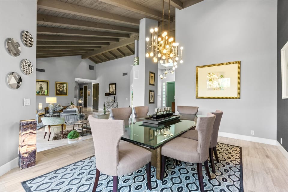 Open dining area with designer chandelier and mid-century style