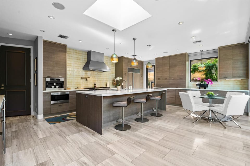 Chef's kitchen with oversized island and modern dining area