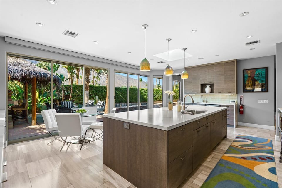 Kitchen opens to outdoor dining and private Palm Springs oasis