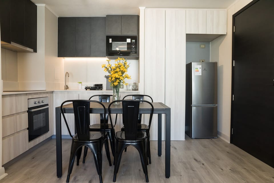 Stylish kitchen with modern appliances and a cozy dining area, perfect for intimate meals.