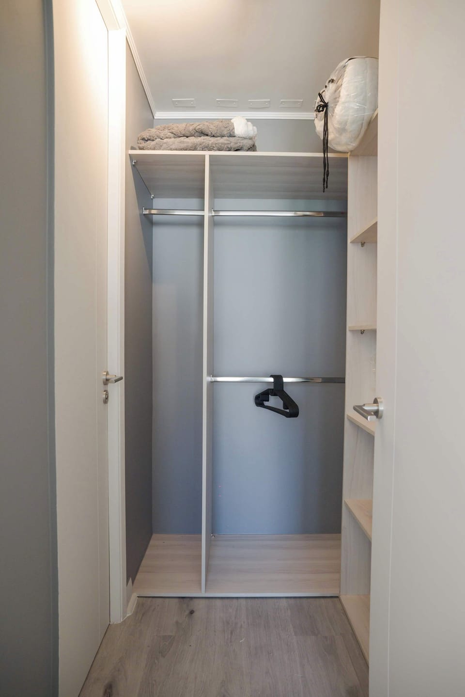 Organize your belongings in this spacious walk-in closet, complete with cozy blankets and ample storage.