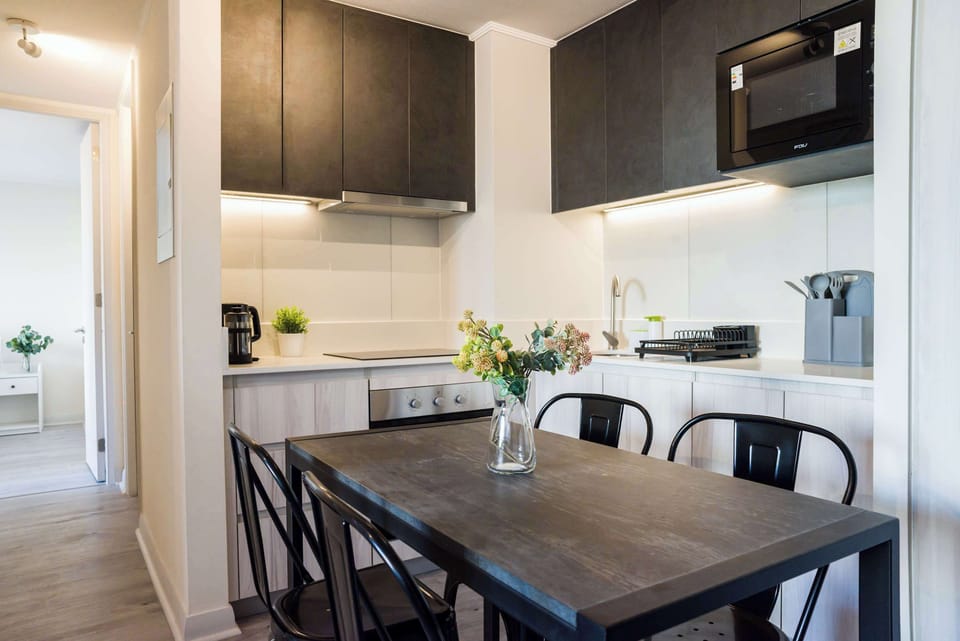 Modern kitchen and dining area with sleek design, perfect for stylish meals.