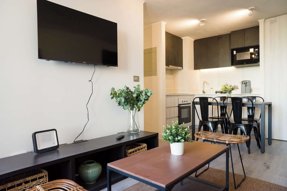 Modern living area with sleek kitchen and cozy seating, perfect for unwinding after city adventures.