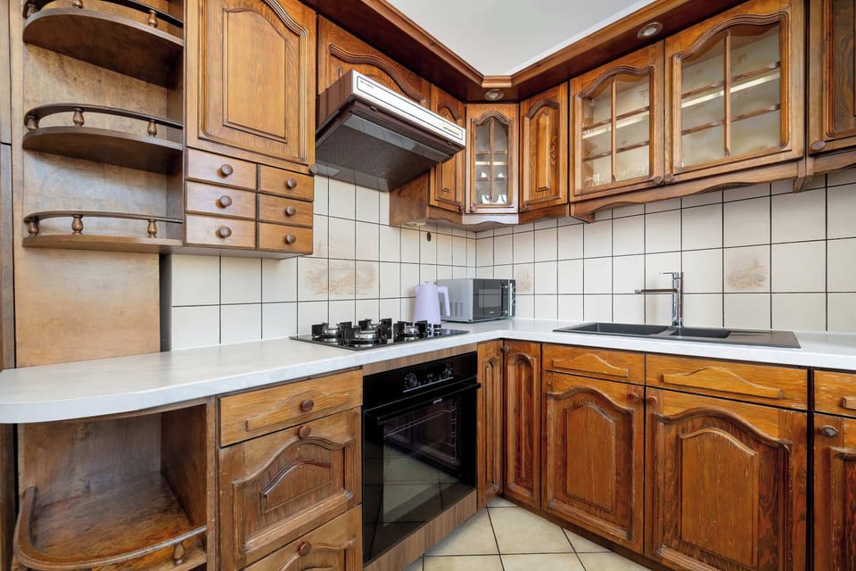 Kitchen corner with wooden cabinetry and countertop space