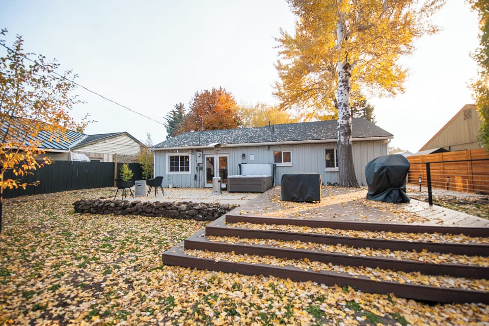 Large fully-fenced back yard with hot tub, patio heater, fire pit, grill