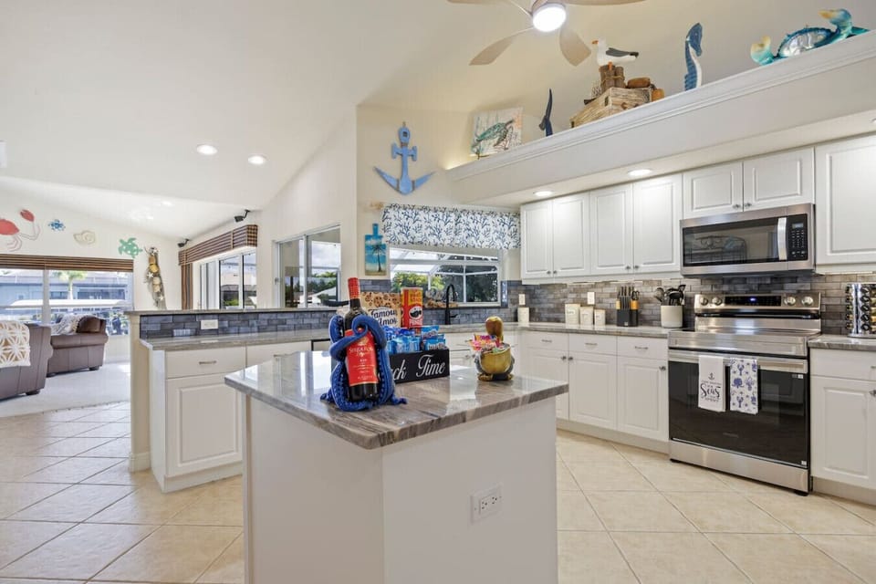Fully stocked kitchen with granite countertops and stainless steel appliances