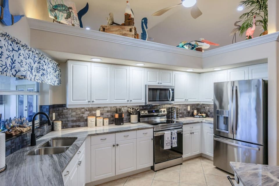 Fully stocked kitchen with granite countertops and stainless steel appliances
