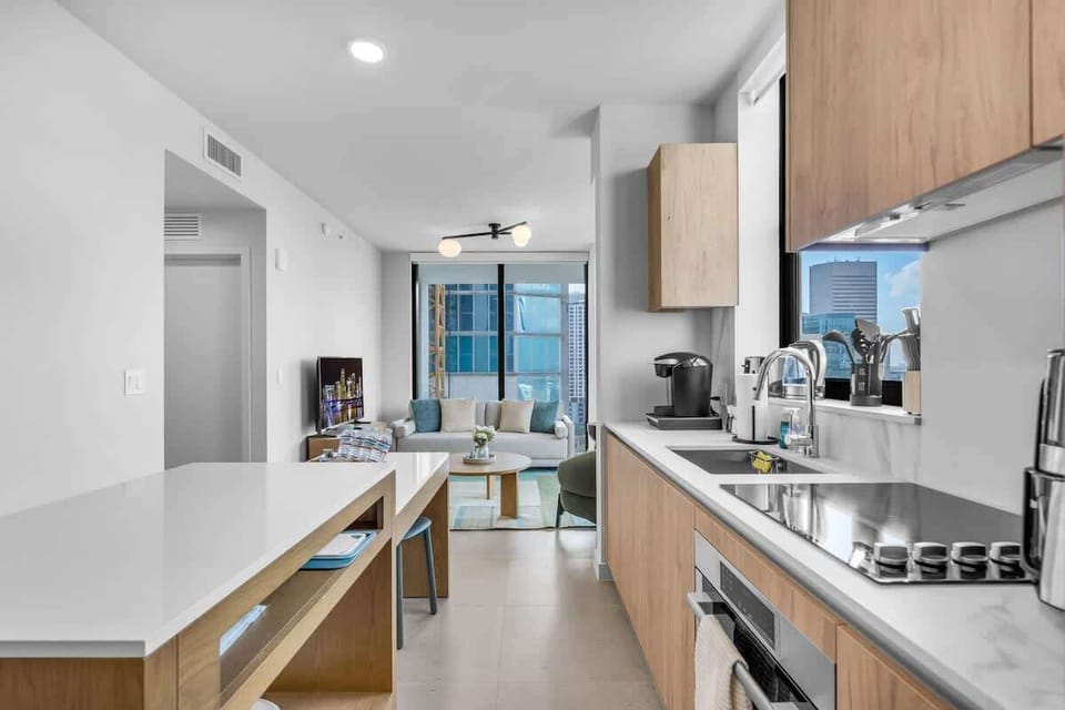 Stay connected. This open-concept design ensures you're never left out of the conversation, linking the fully equipped kitchen directly to the living area.