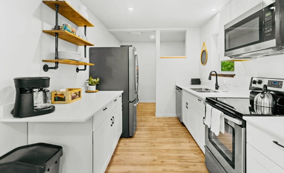 Fully equipped kitchen with modern appliances and open shelving