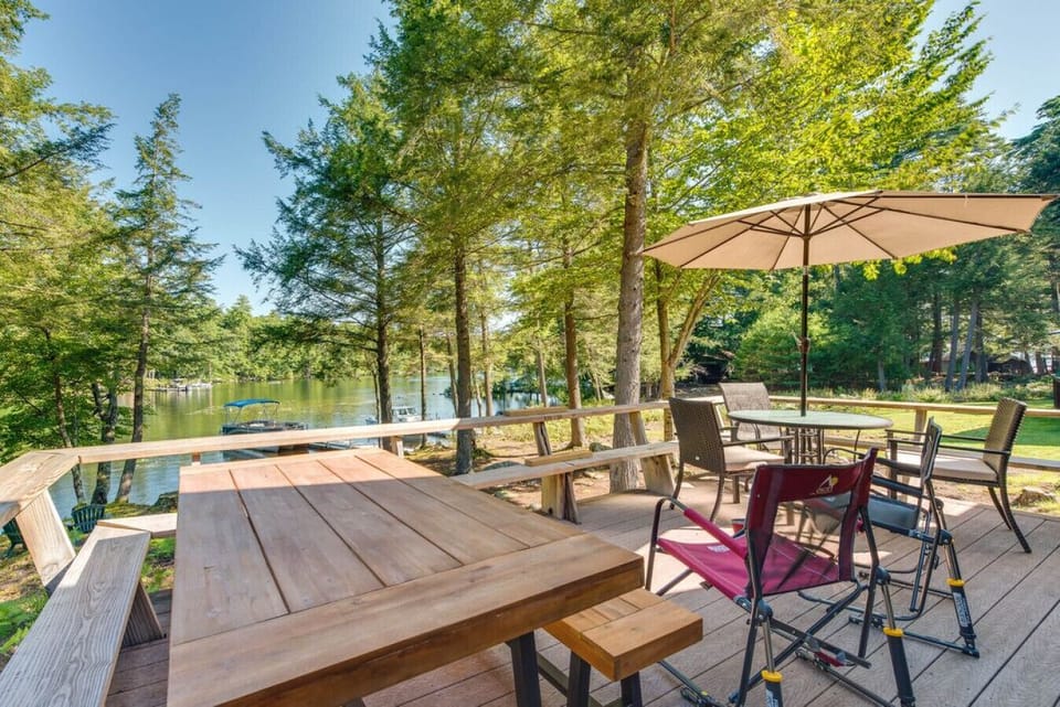 Spacious lakefront deck with outdoor dining and water views