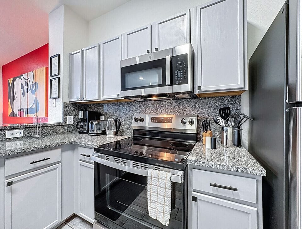Modern kitchen featuring granite countertops, ample cabinet space, and everything needed for home-cooked meals.