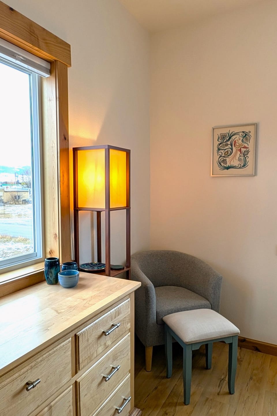 Cozy reading nook with lamp, in the corner of the bedroom.