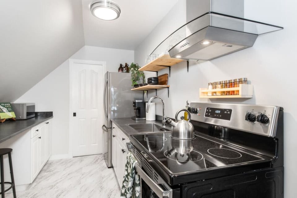 Modern, fully-equipped kitchen with stainless steel appliances and ample counter space for preparing your favorite meals.