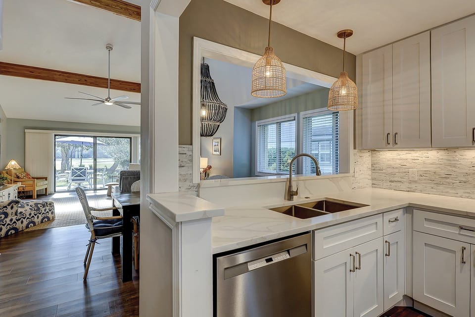 Fully stocked kitchen with stainless steel appliances.