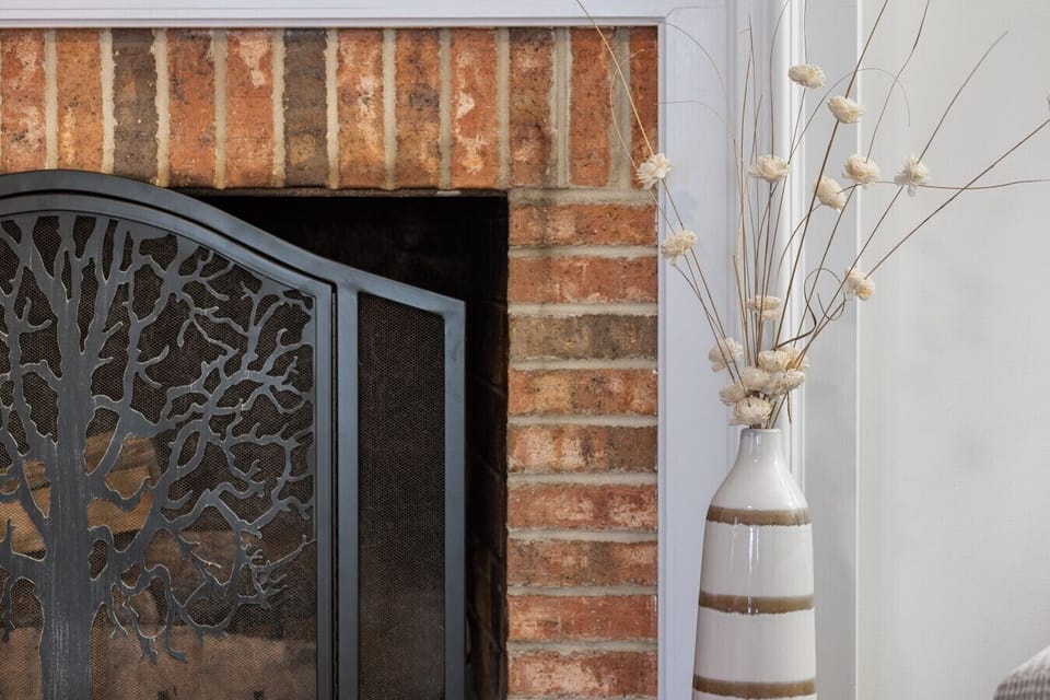 Charming brick fireplace with elegant decorative details.