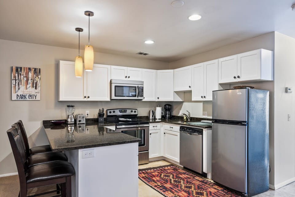 Open kitchen with full-size appliances, bar seating, and ample counter space—everything you need to prepare meals and snacks with ease.