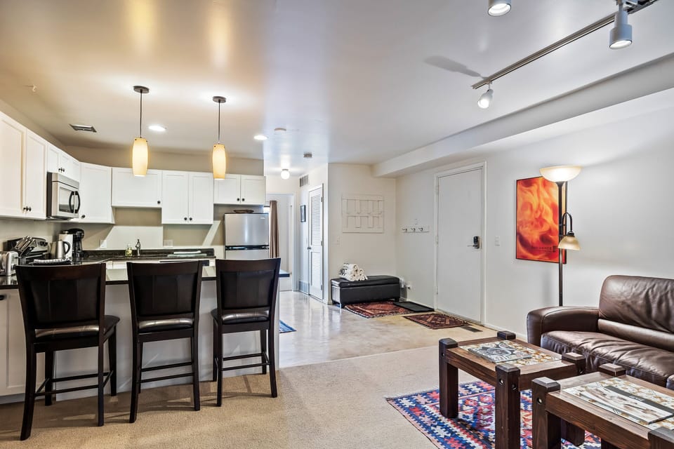 Bright open-concept layout featuring comfortable seating, dining space, and a fully equipped kitchen—perfect for relaxing together after a day in the mountains.