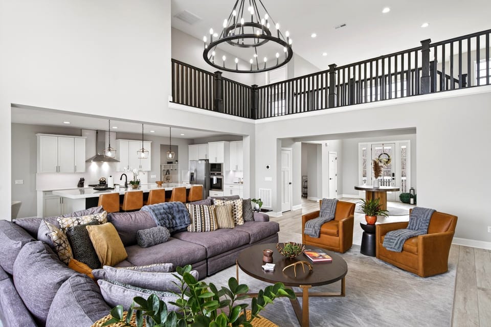 Living room with soaring, vaulted ceiling, fireplace, and Smart TV for streaming