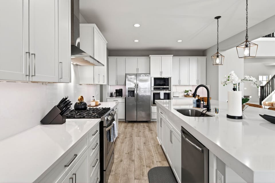 Beautifully equipped kitchen with spacious island, gas range, dishwasher, and combination drip-style and Keurig coffee maker