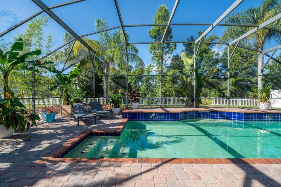 South-facing private pool surrounded by tropical plants, looking onto a nature preserve.