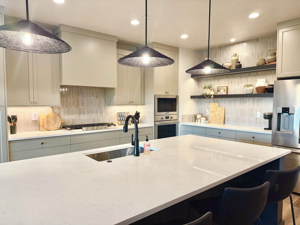 Downstairs full kitchen with stainless steel appliances and bar seating for 4.