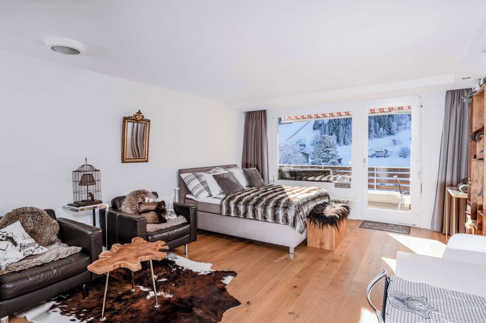 Bright bedroom with cozy sofa and plenty of natural light