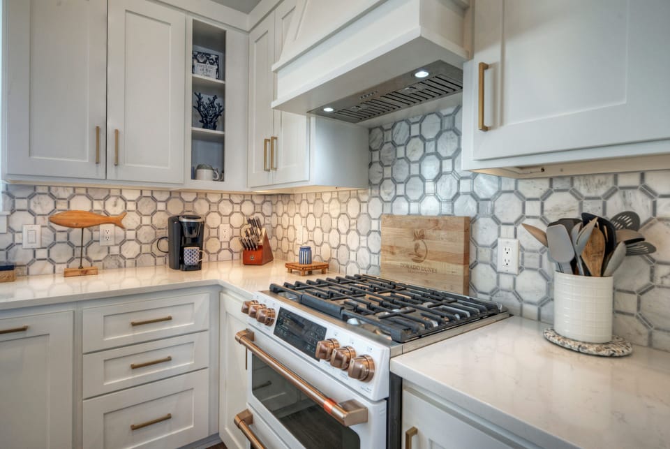 High-end kitchen stove with a decorative hexagonal tile backsplash.