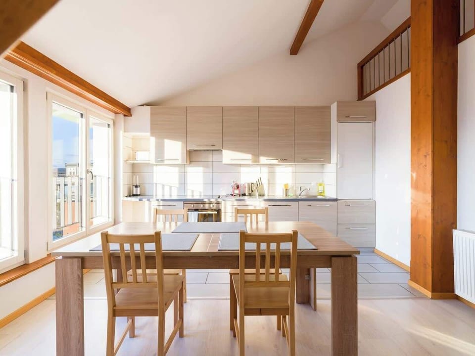 Modern kitchen with full appliances and dining space
