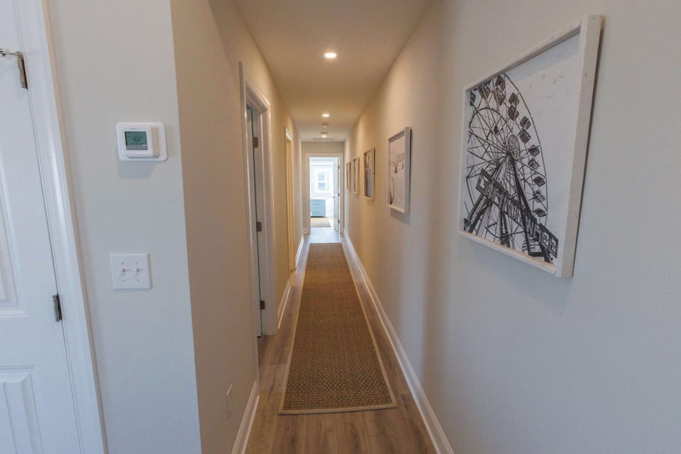 Bright and welcoming hallway connecting all bedrooms and living spaces in this thoughtfully designed luxury condo.