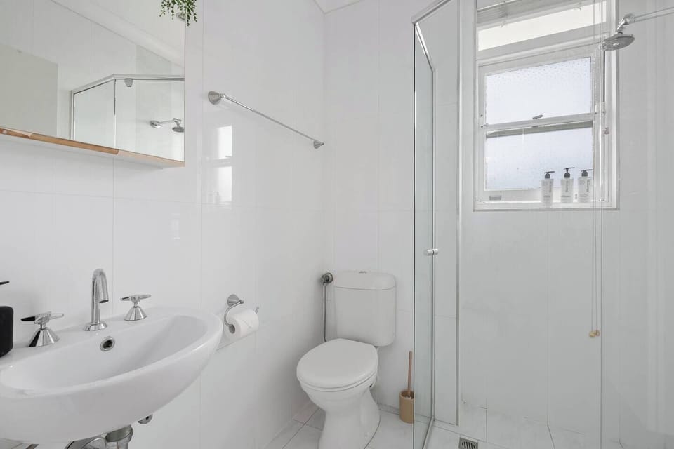 The bathroom features a walk-in shower, complimentary toiletries, hair dryer and clean finishes for a refreshed start or end to each day.