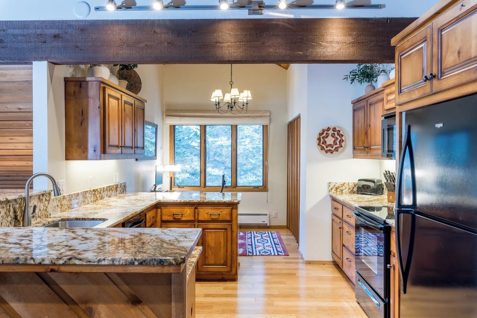 Your gourmet kitchen features granite countertops, stainless steel appliances, and rustic wood cabinets—perfect for creating memorable meals together.