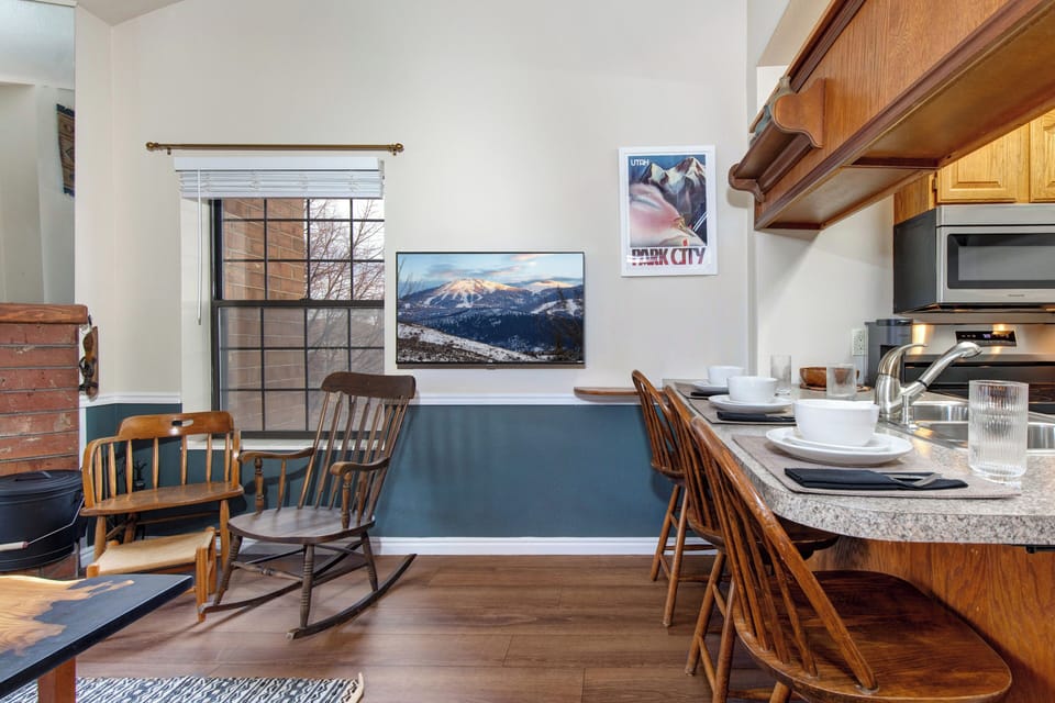Gather around your welcoming kitchen island, where granite counters and warm wood create the perfect space for morning coffee or evening conversations.