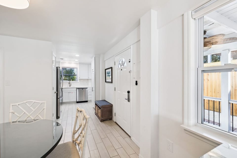 Step into your bright, airy retreat where white walls meet warm wood floors, creating the perfect backdrop for relaxation.