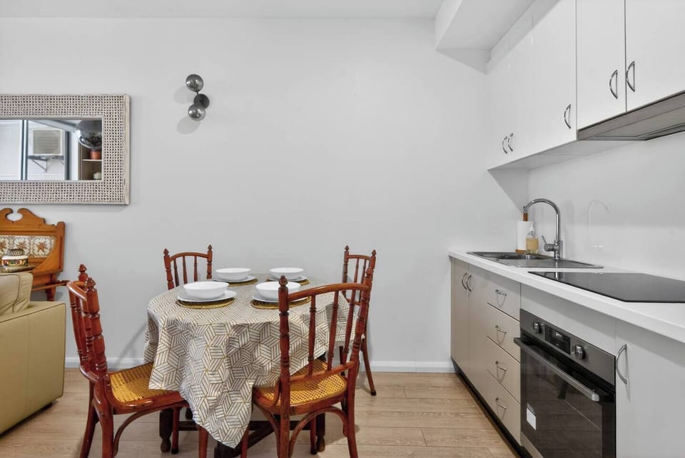 The dining setting offers a comfortable spot for shared meals, takeaway feasts, or lingering breakfasts before heading out to explore Potts Point.
