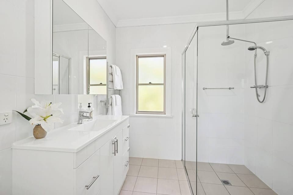 Enjoy privacy in the primary ensuite, set with a spacious vanity and rainfall shower.