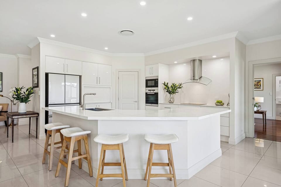 The kitchen is bright, spacious, and designed for shared cooking with premium appliances and a central island.