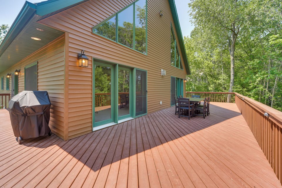 Large wrap around deck with a table and BBQ