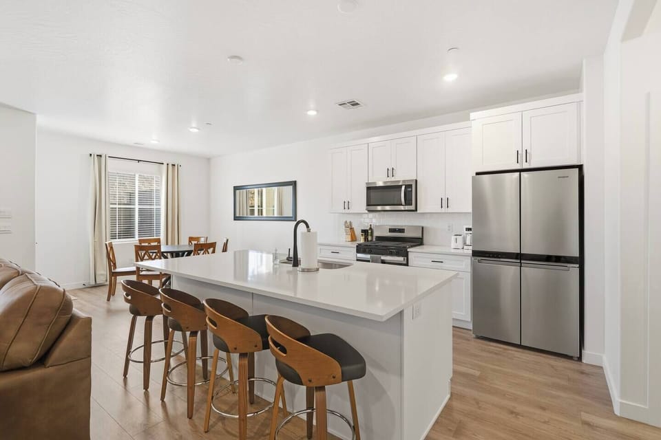 Modern kitchen with island seating and dining space.