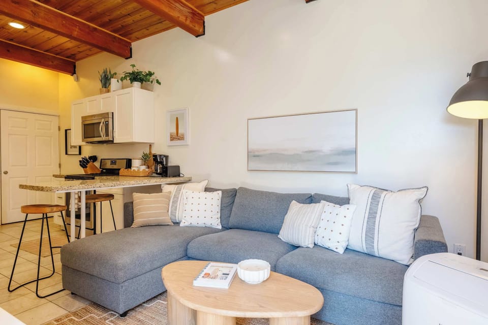 Open living space with warm wood-beamed ceilings