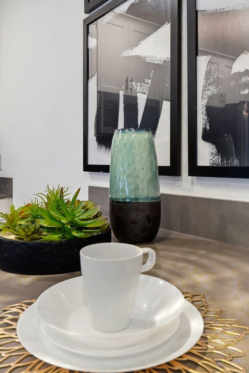 modern kitchen countertop with white dishware and decorative accents