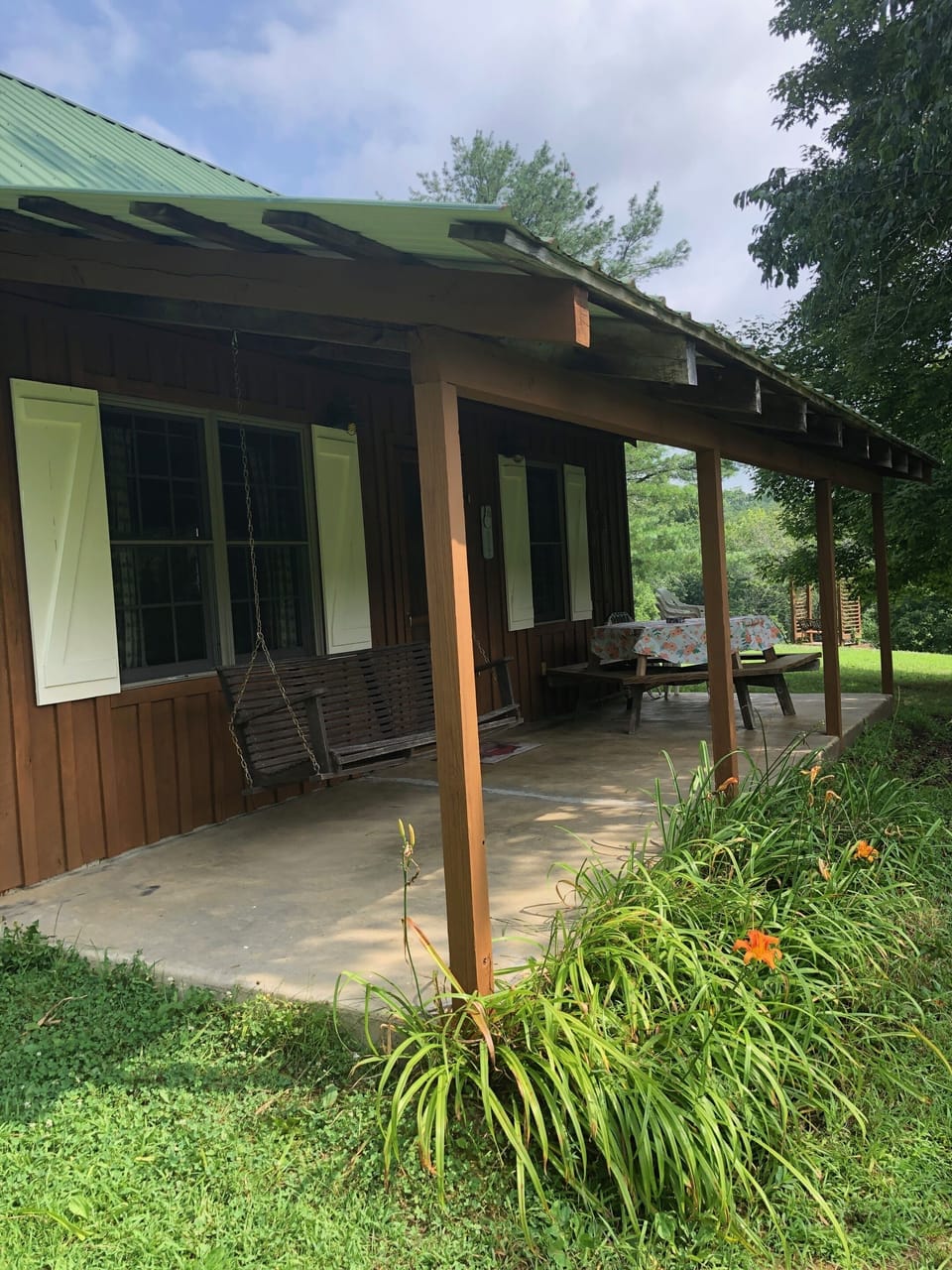 Back Porch Entrance With Swing and Picnic Table