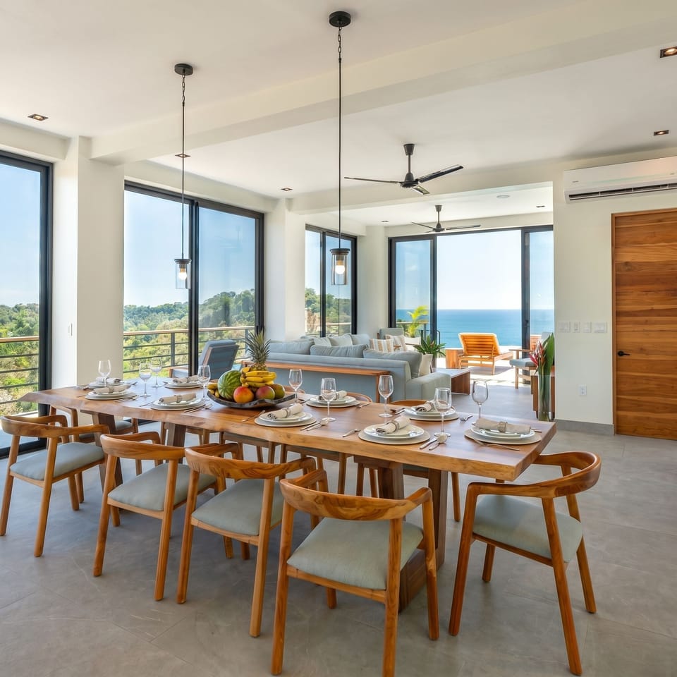 Open-concept living and dining area with panoramic ocean and jungle views.