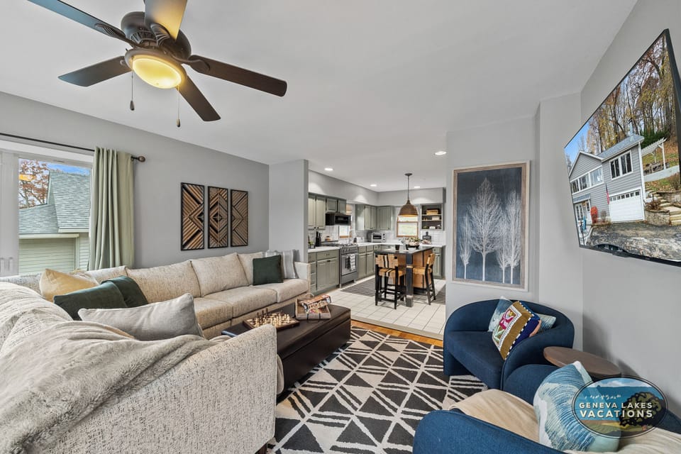 Living room with smart TV (stream your own providers) and open to kitchen