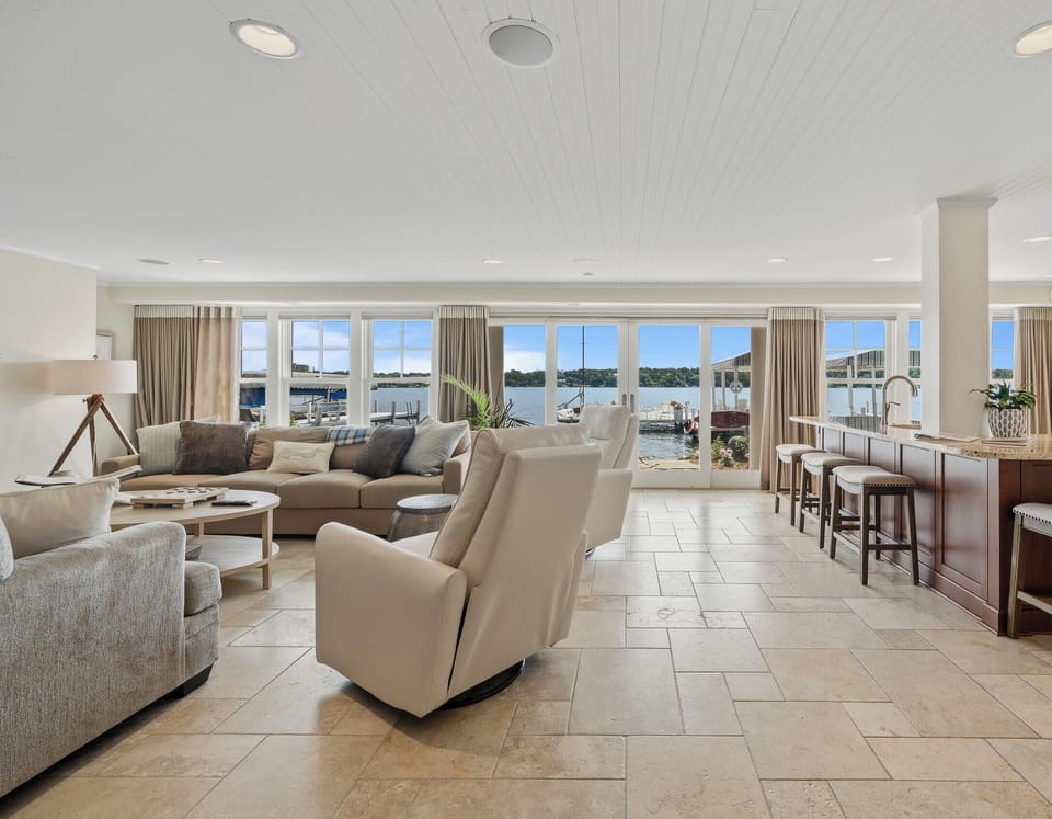 Main level living room with fireplace, fully equipped kitchen. Walk out to patio and pier.