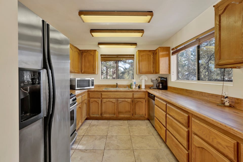 Fully equipped cabin kitchen with ample cabinetry, stove, fridge, microwave, and coffee maker—perfect for cooking meals, morning coffee, and feeling right at home on your stay.