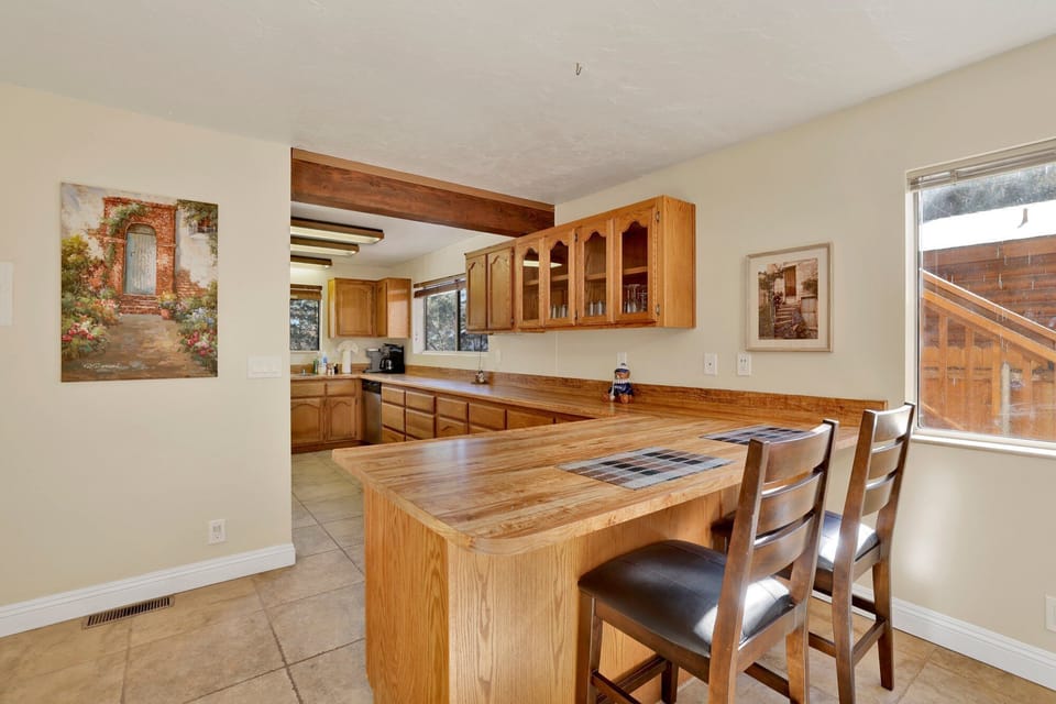 Fully equipped cabin kitchen with ample cabinetry, stove, fridge, microwave, and coffee maker—perfect for cooking meals, morning coffee, and feeling right at home on your stay.