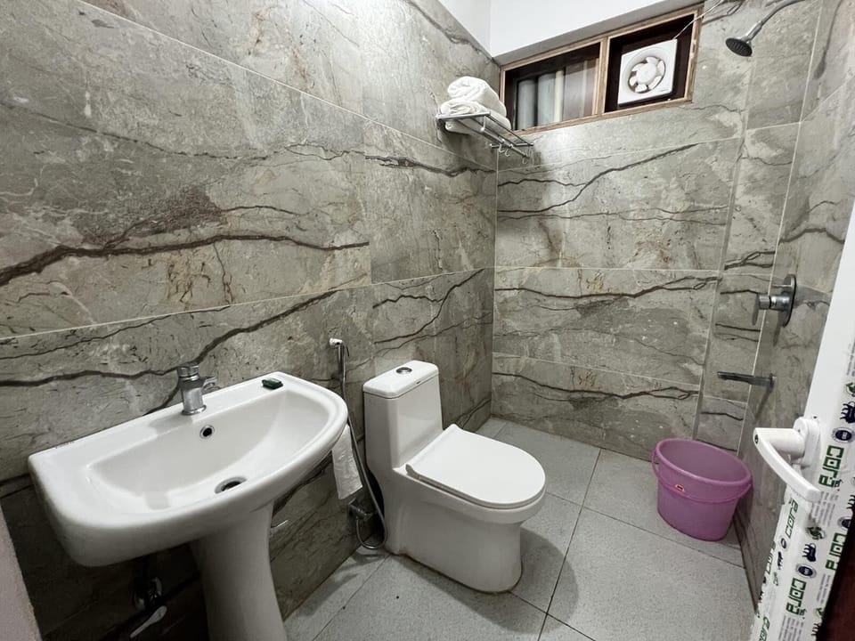 Signature Room | Bathroom | Shower, towels
