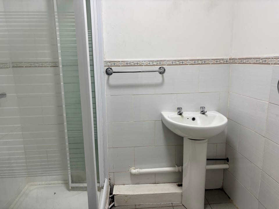 Shower, hair dryer, towels, toilet paper