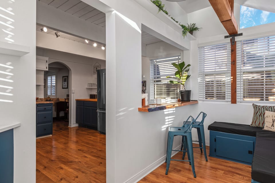 Kitchen view with bar counter and stools.