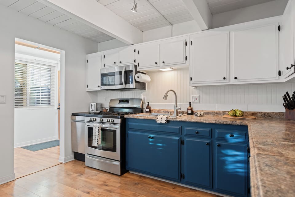 Stylish kitchen with contrasting blue and white cabinets.